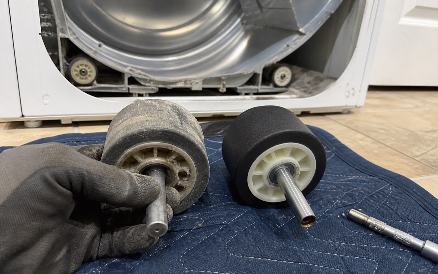 Old and new dryer drum support rollers compared during service