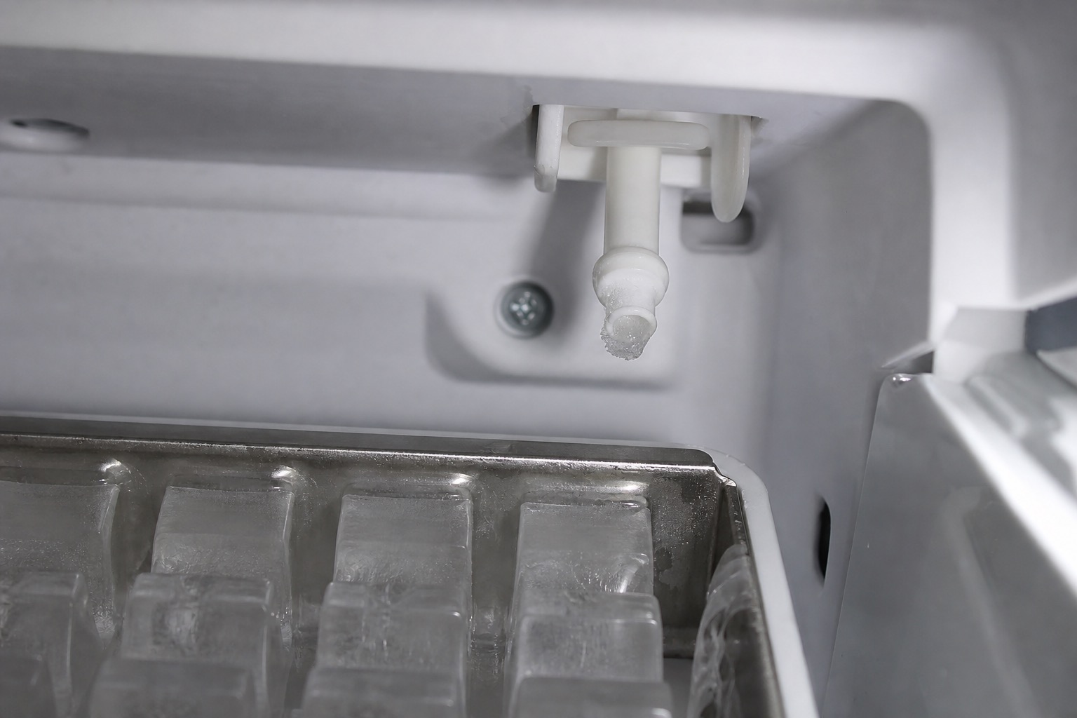 Frozen ice maker fill tube above the ice mold