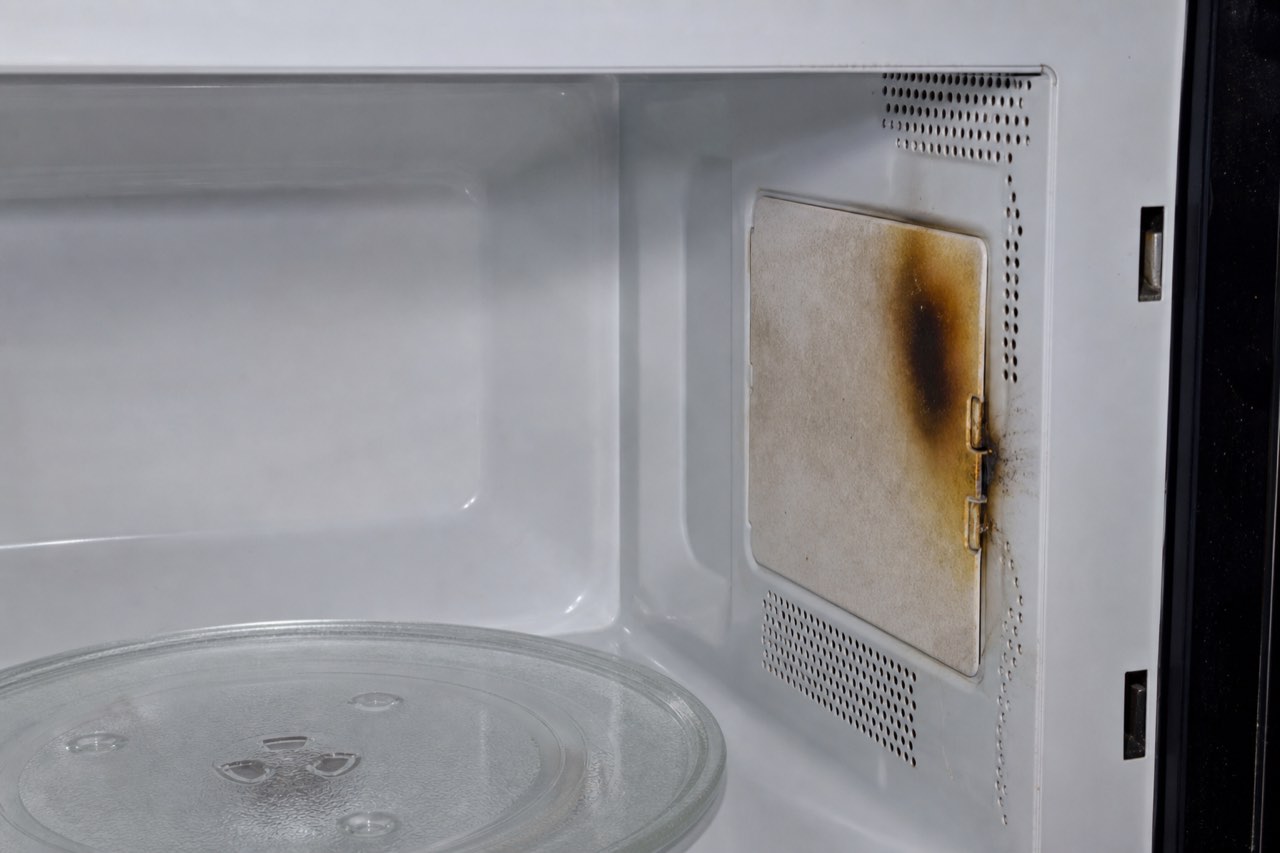 Burned microwave waveguide cover inside the cooking cavity