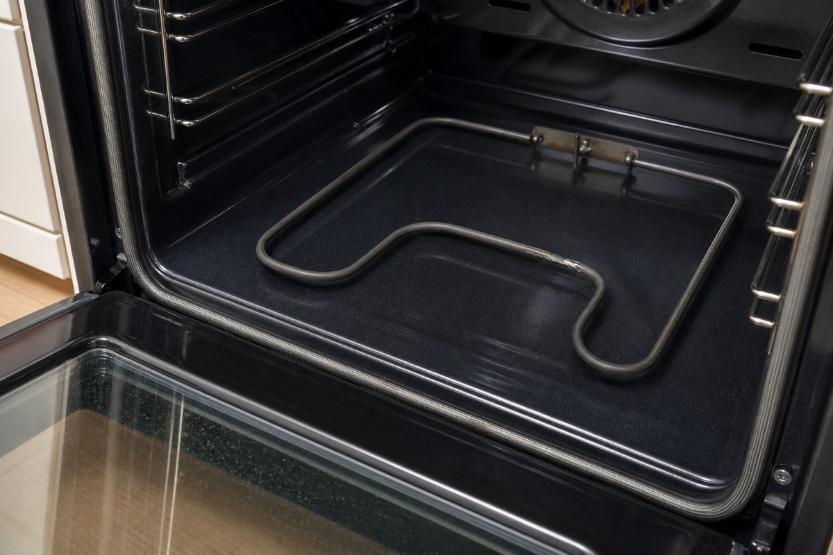 Electric oven bake element being inspected for failure
