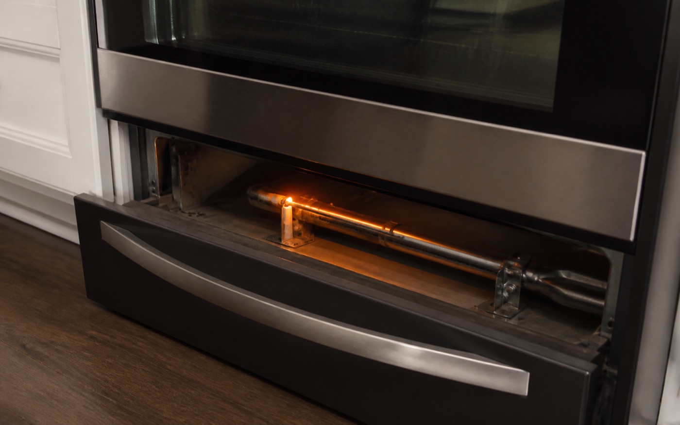 Gas oven igniter glowing near the burner during diagnosis