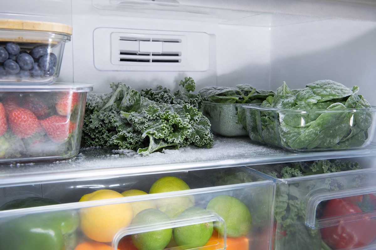 Frozen produce stored near a cold-air vent in a refrigerator fresh-food section