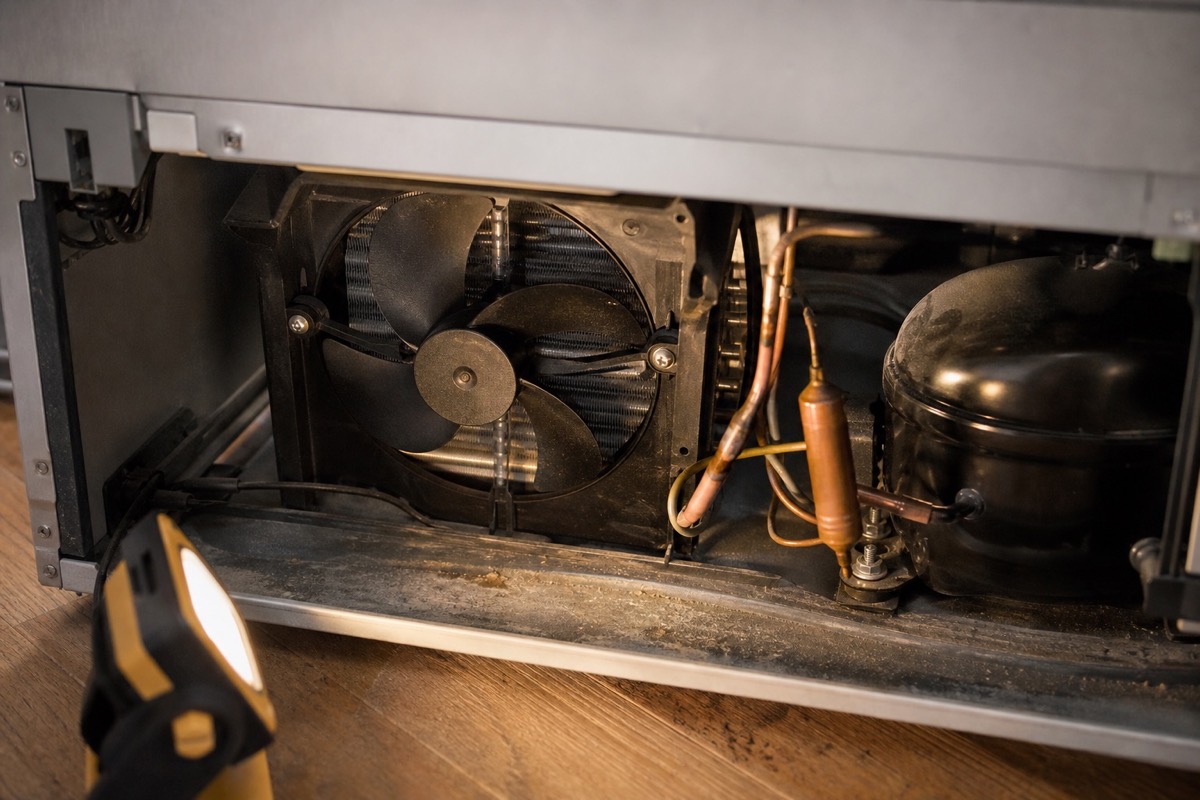 Rear condenser fan and compressor area illuminated by a work light