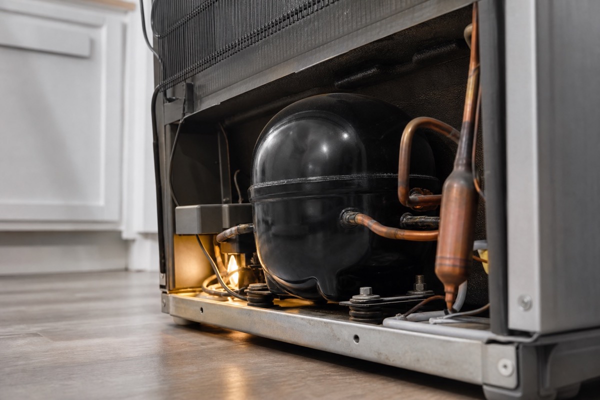 Close view of a refrigerator compressor and copper lines