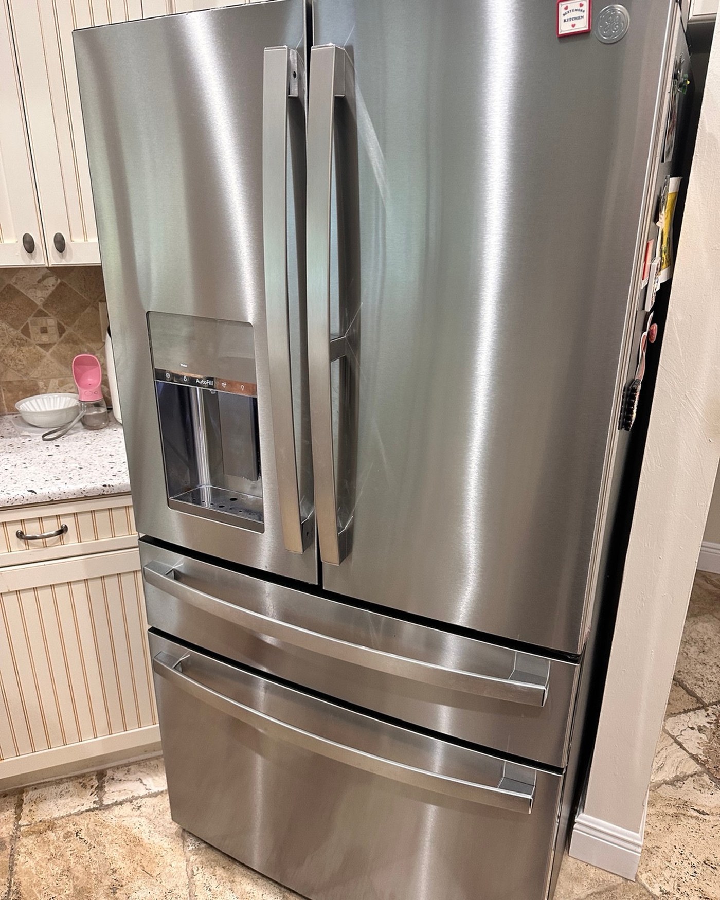 Stainless steel GE refrigerator with an external water dispenser.