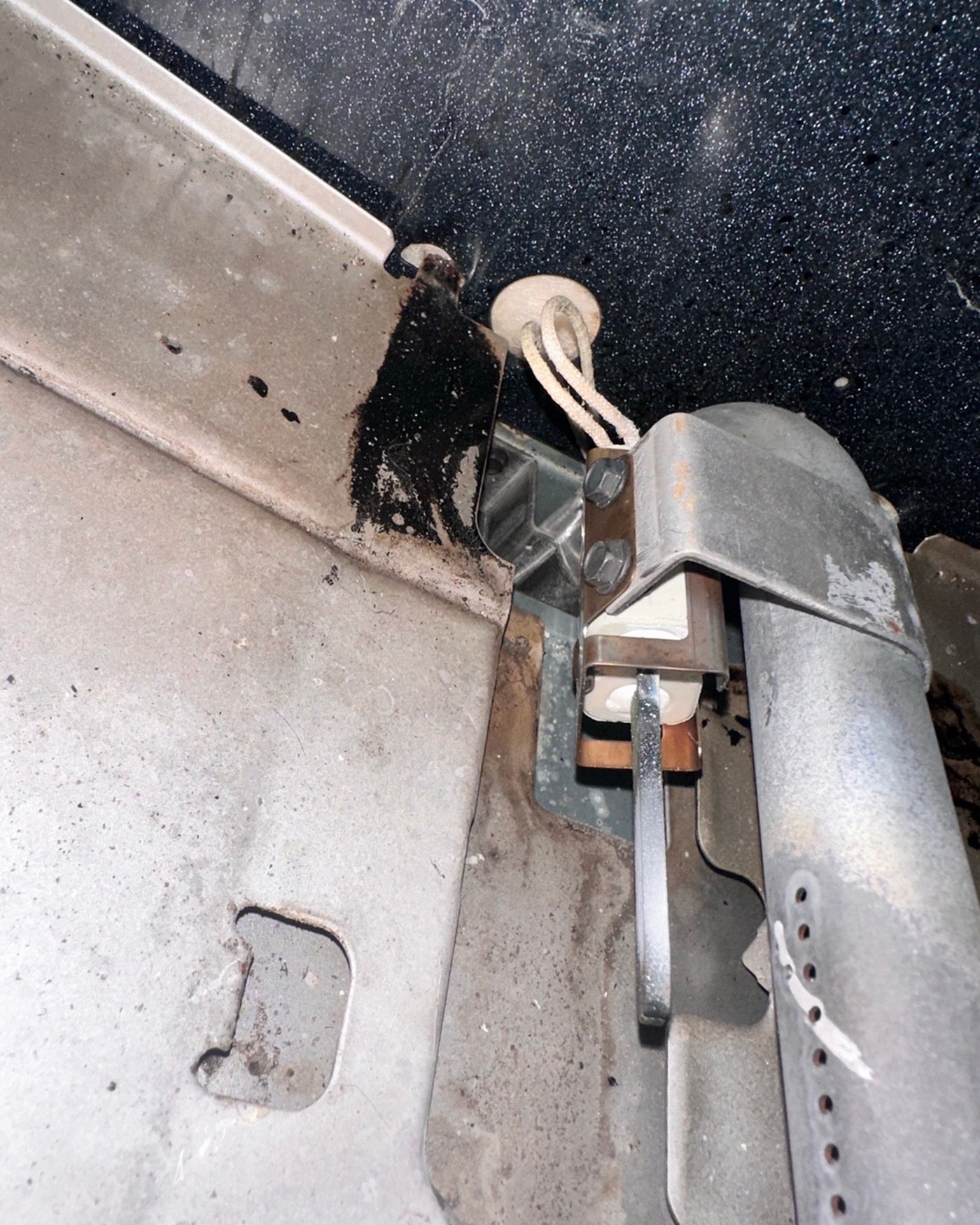 Gas oven burner and igniter area.