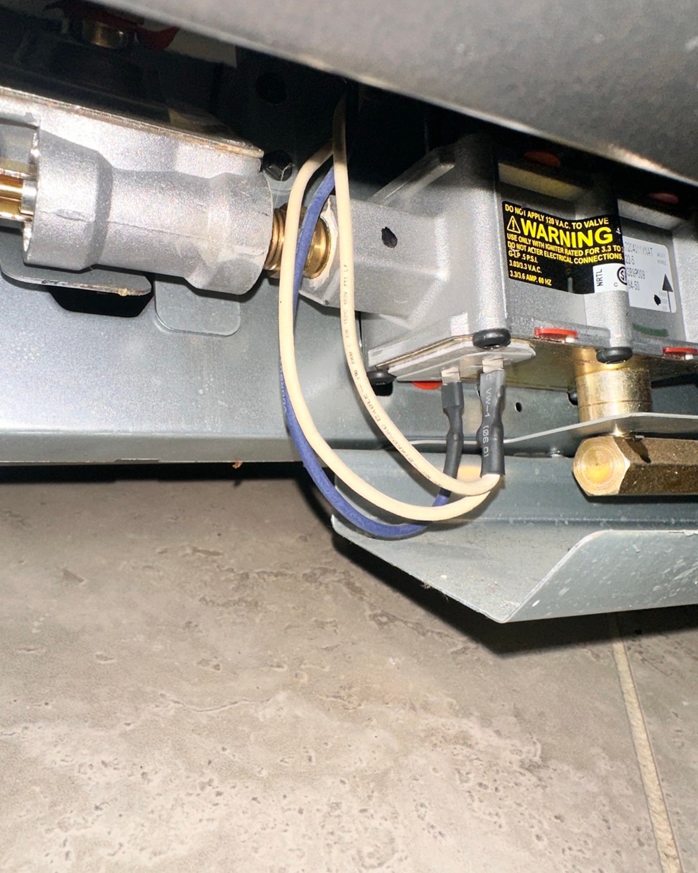 Gas oven wiring and connection area.