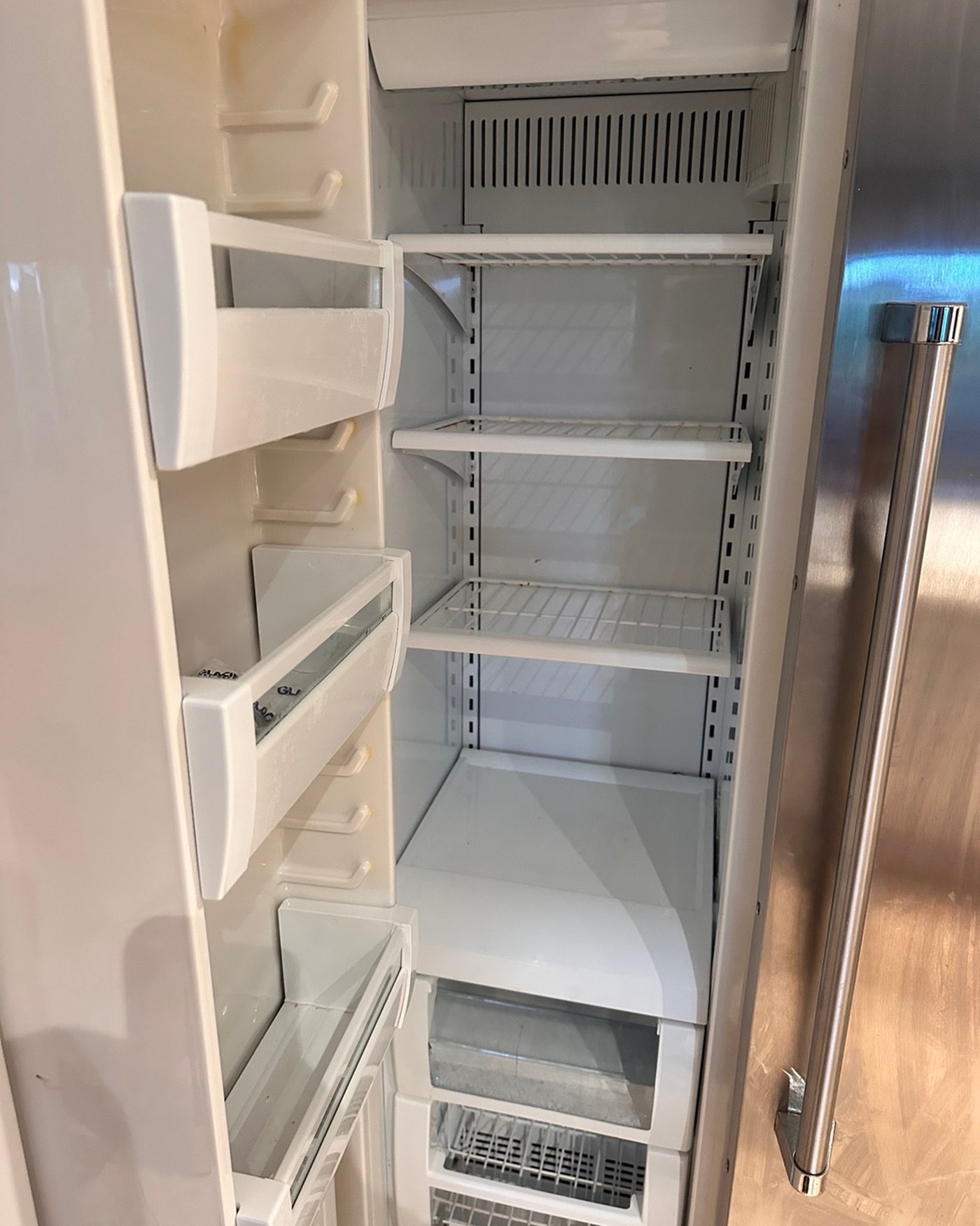 Open Viking refrigerator compartment with its interior panels and shelves in place.