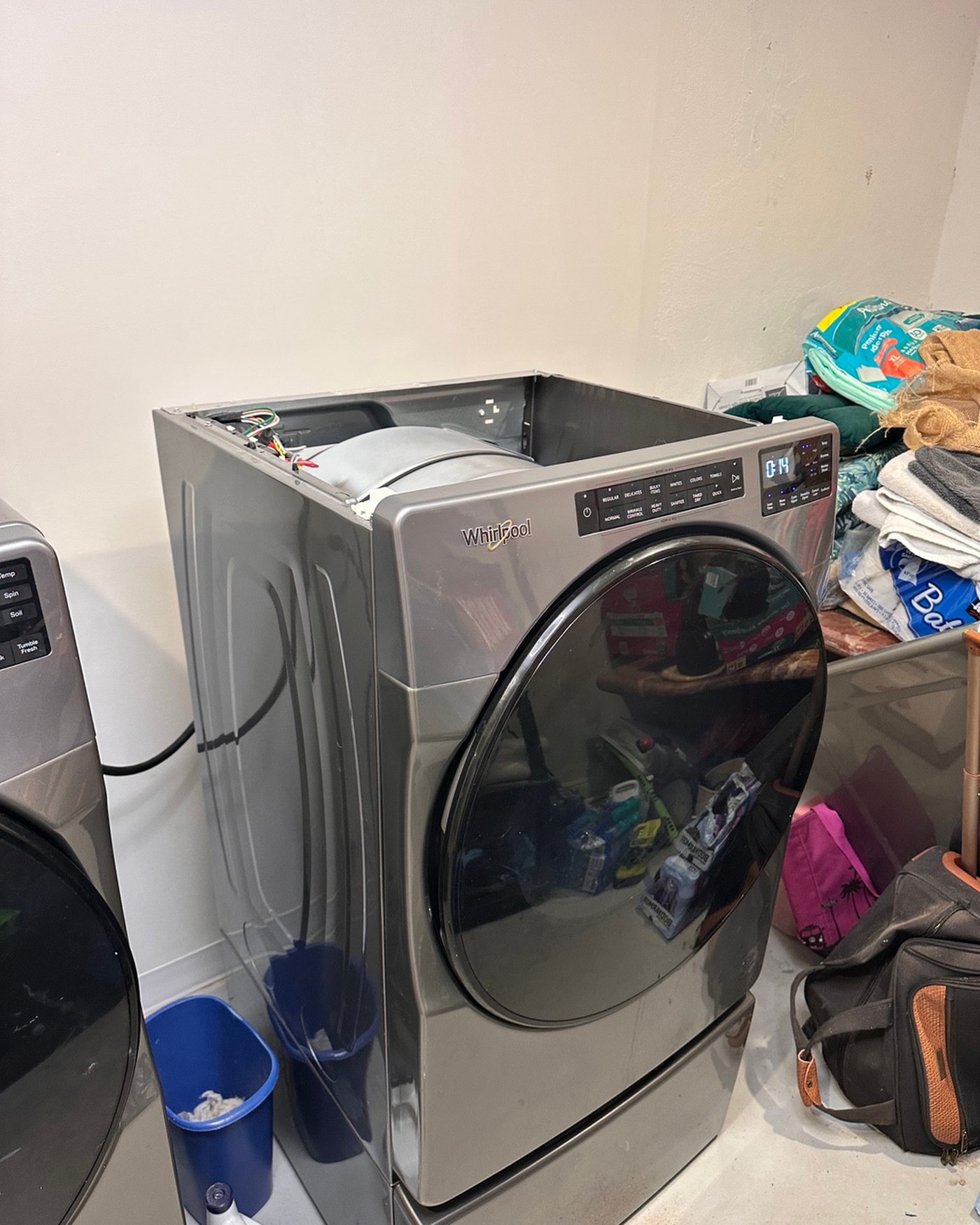 Whirlpool front-load dryer with the top panel removed.