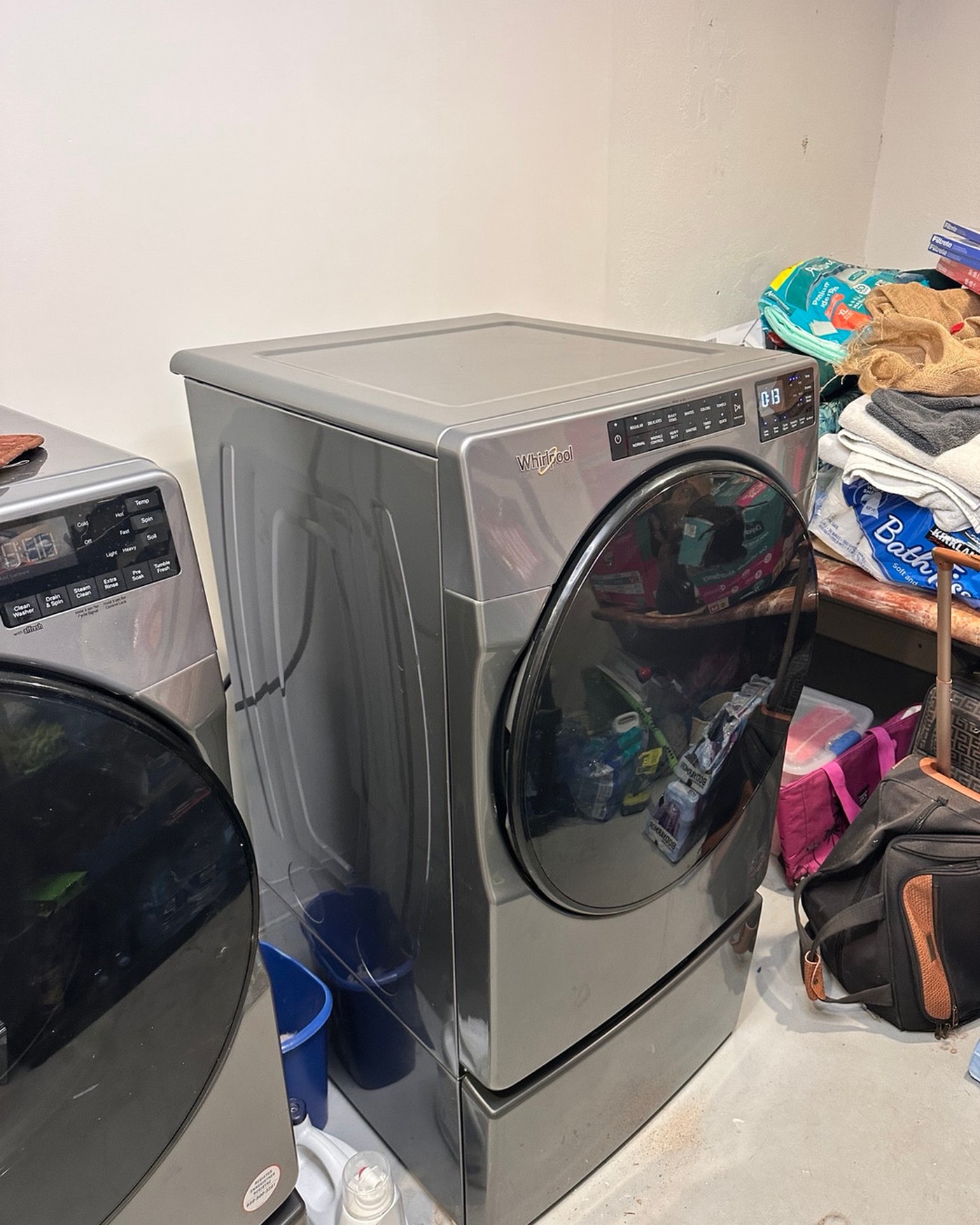 Whirlpool front-load dryer with its top panel in place.