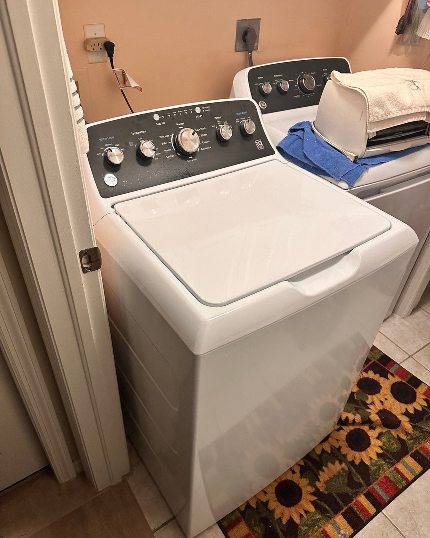 White top-load washer with a dark control panel.