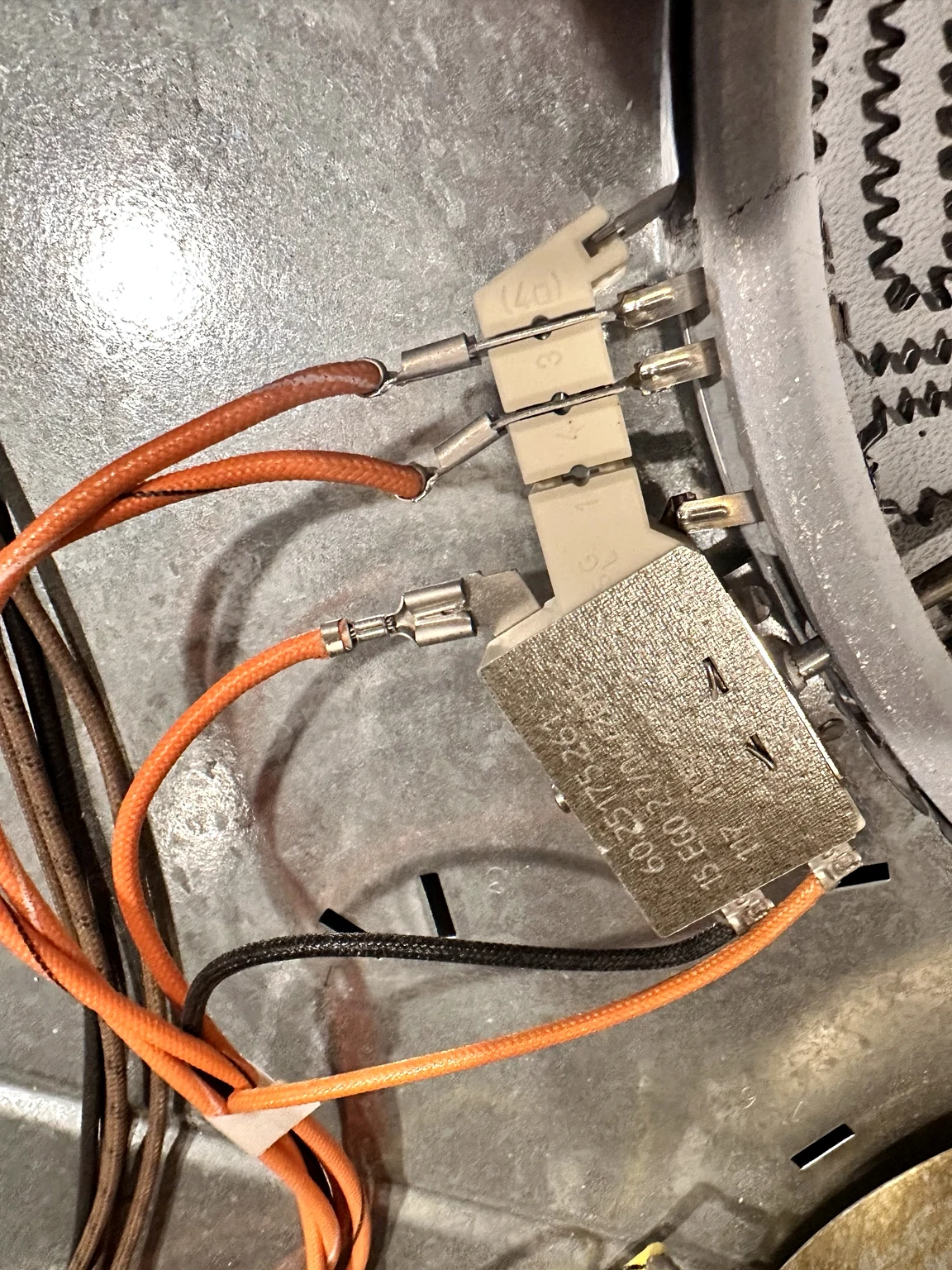 Dual radiant burner wiring and control connections checked during electric range repair