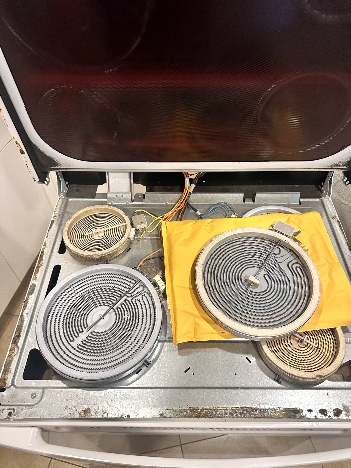 Replacement dual radiant surface element positioned during electric range repair