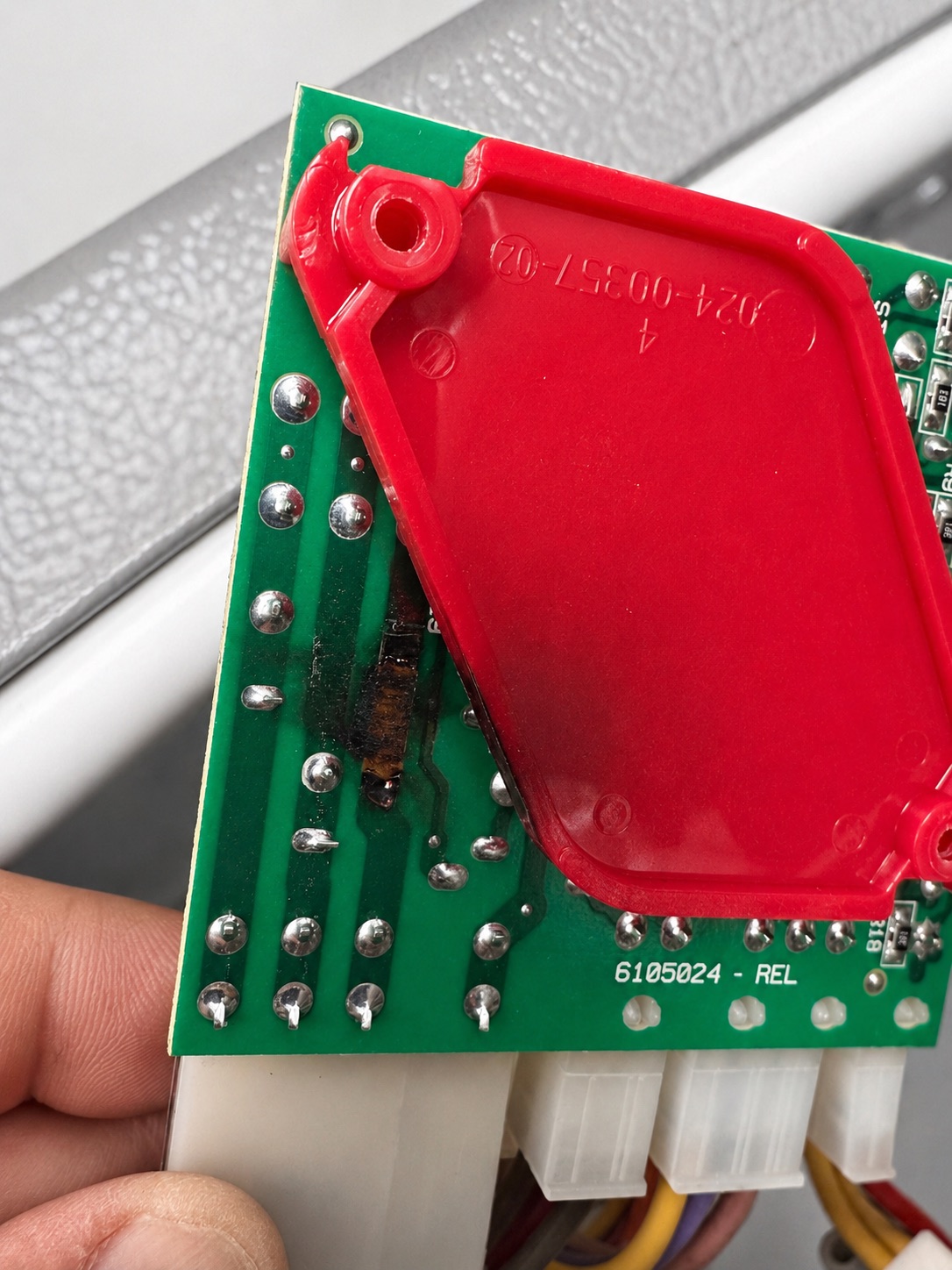 Visible burn damage on a Whirlpool refrigerator control board