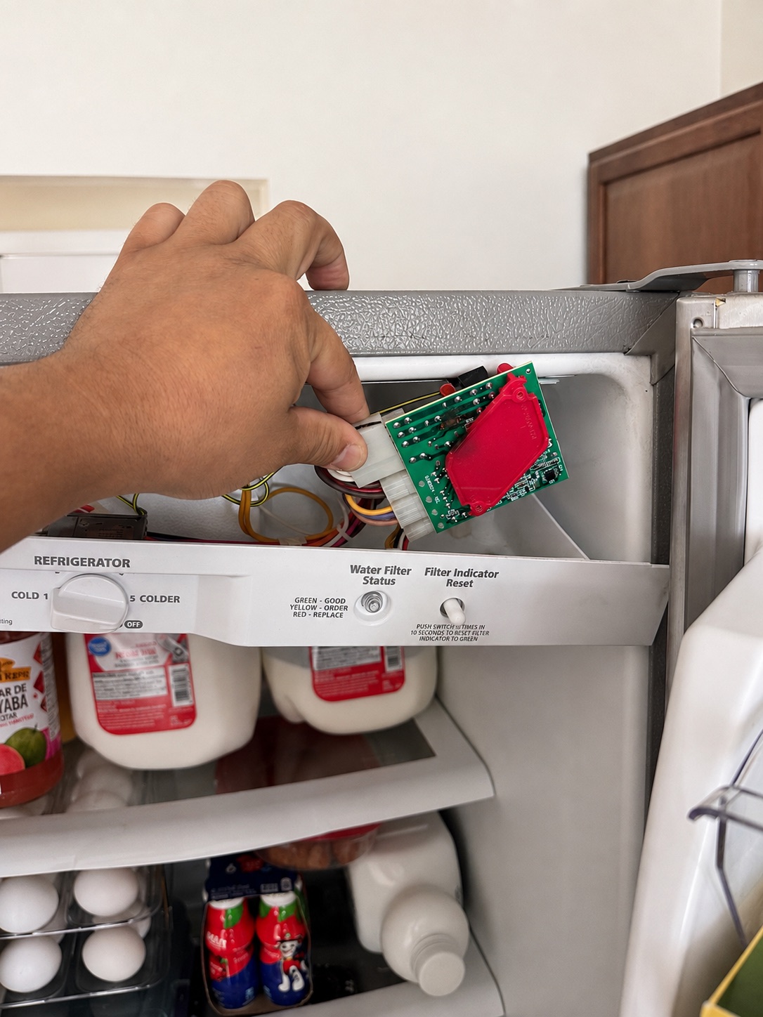 Control board inspection during a Whirlpool refrigerator diagnosis in Cape Coral