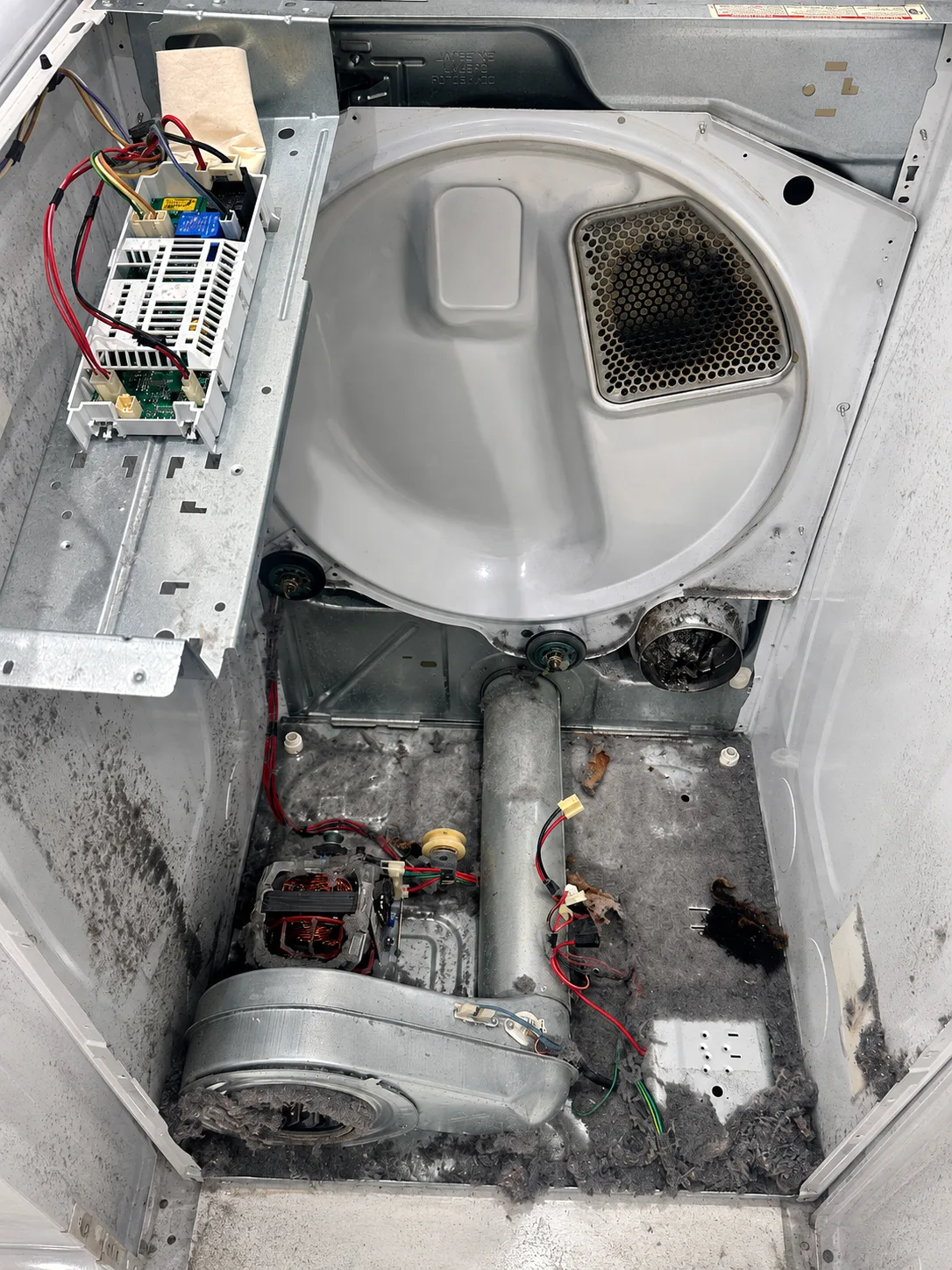 Significant lint buildup inside a Whirlpool electric dryer during Cape Coral repair