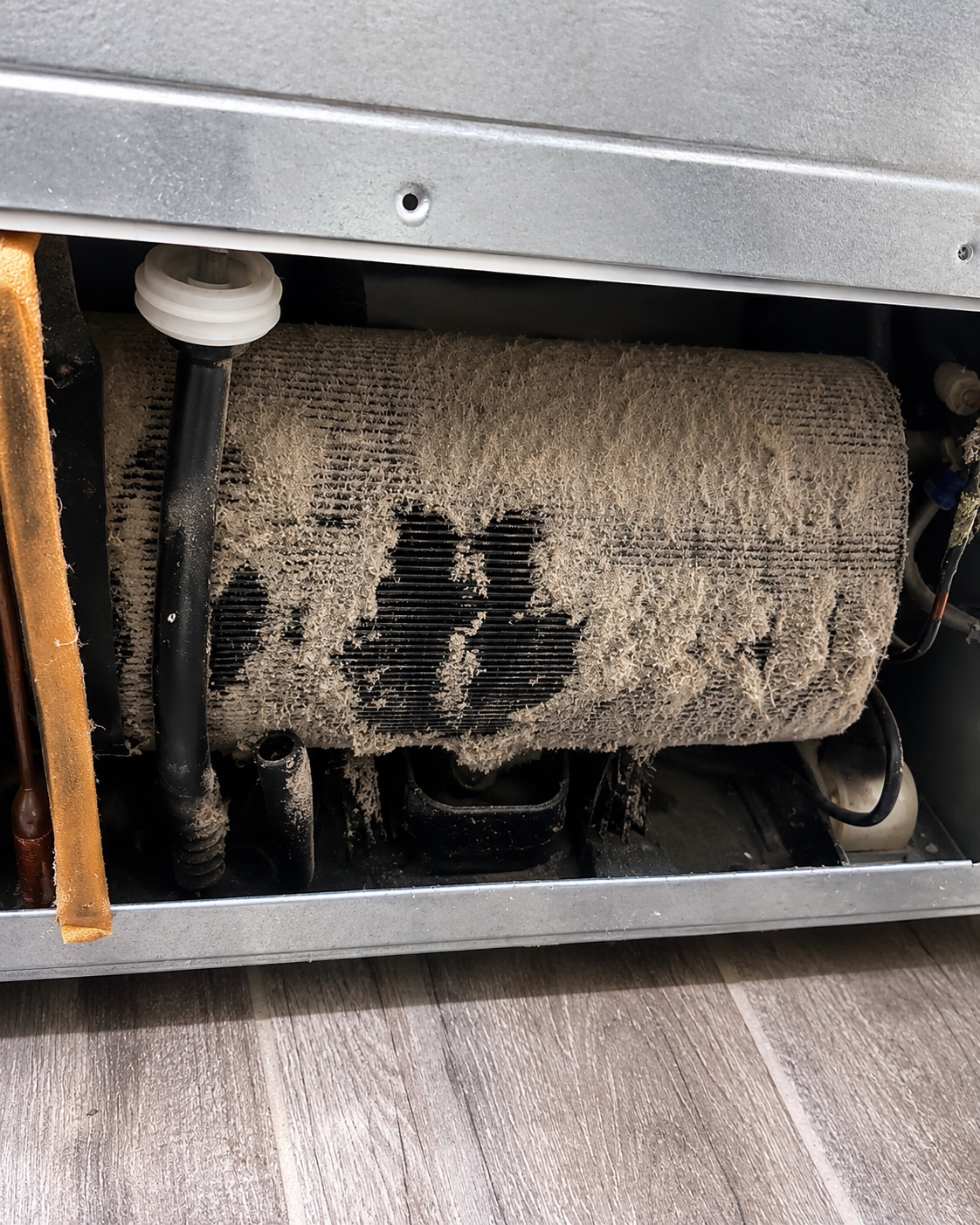 Dust and debris restricting the evaporator coil area on a GE GFE26GGKFBB refrigerator in Fort Myers