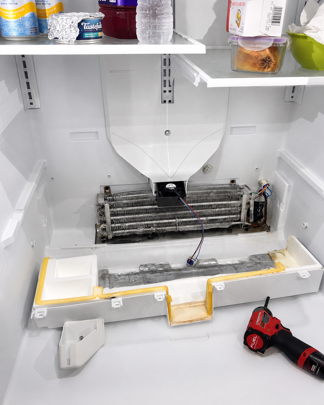 Open evaporator section after cleaning during a GE refrigerator repair in Fort Myers
