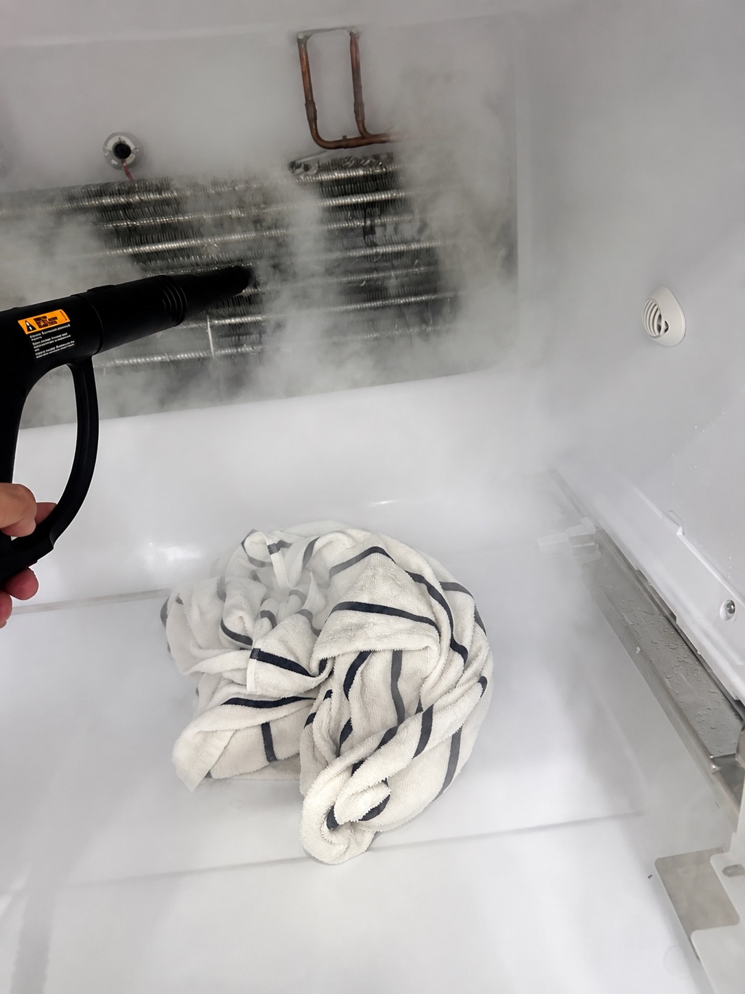 Steam defrost process on a GE GFE26GGKFBB refrigerator evaporator in Fort Myers