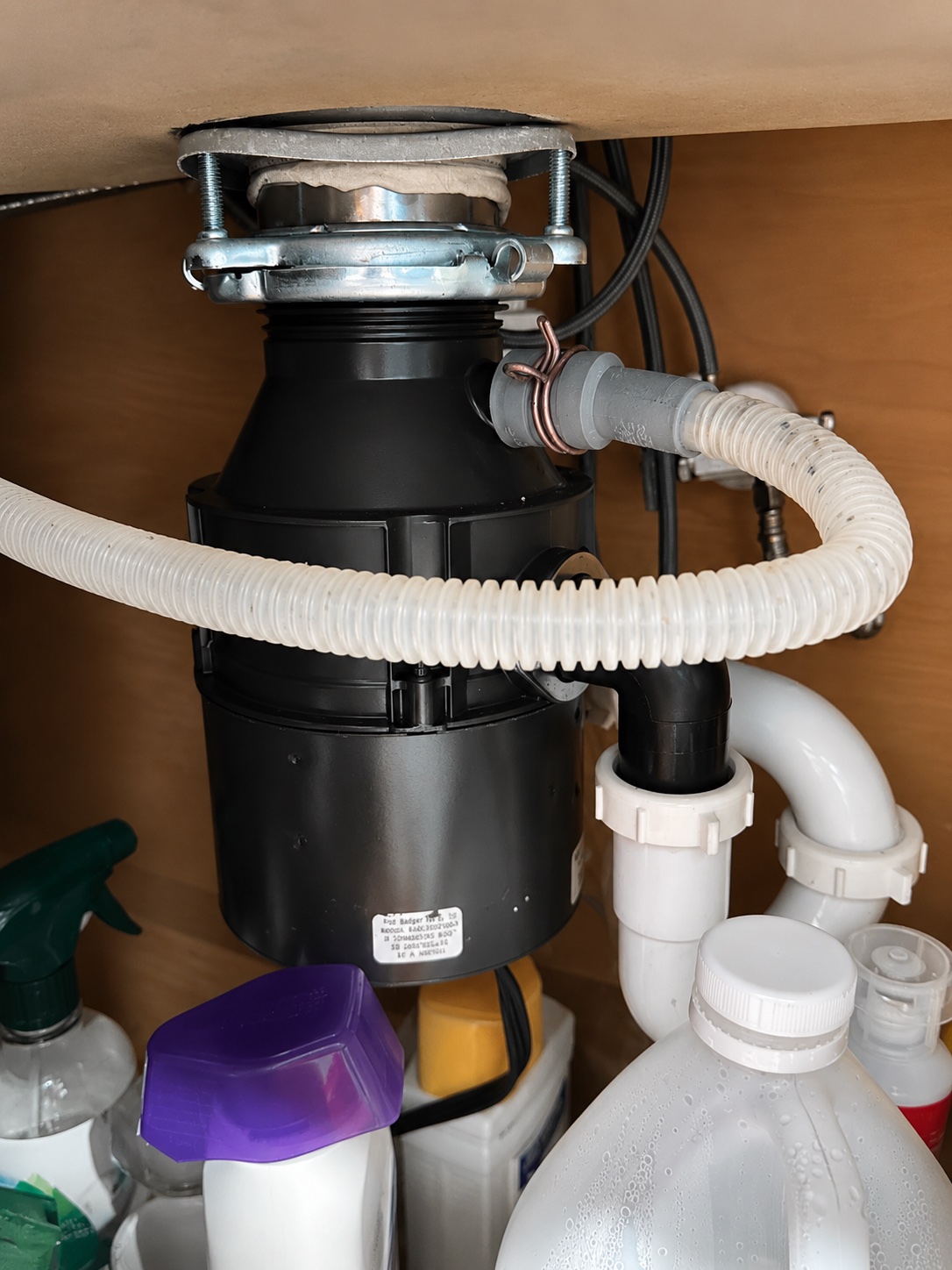 Dishwasher drain hose connected to a garbage disposal during a Fort Myers dishwasher drain diagnosis