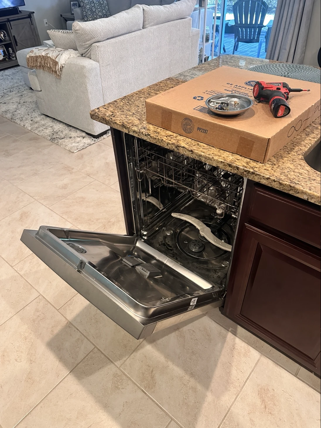 Open GE GDF570SSF4SS dishwasher during heating element replacement in Lehigh Acres