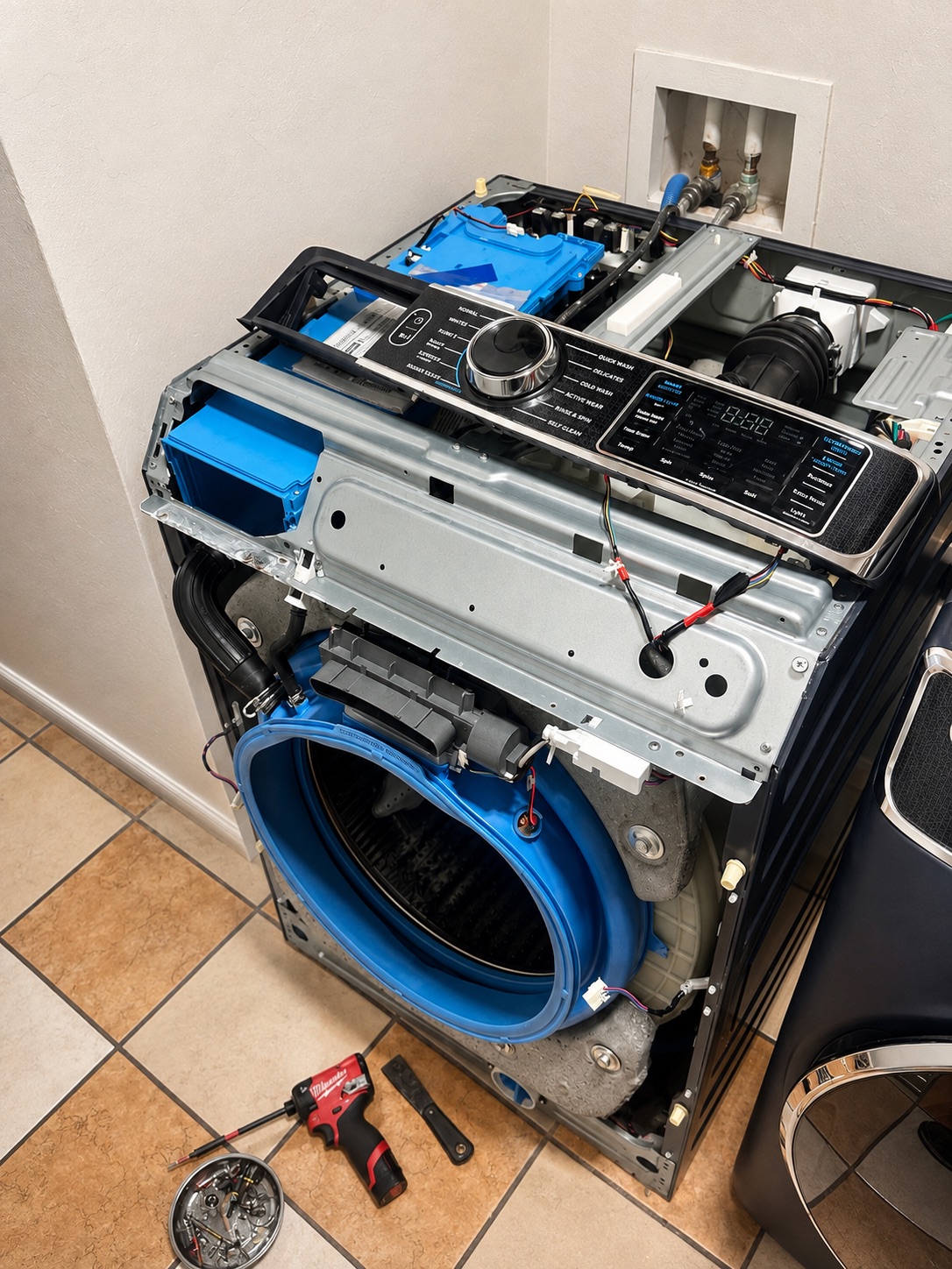GE GFW850SPN1RS washer disassembled for inverter diagnosis in Lehigh Acres Florida