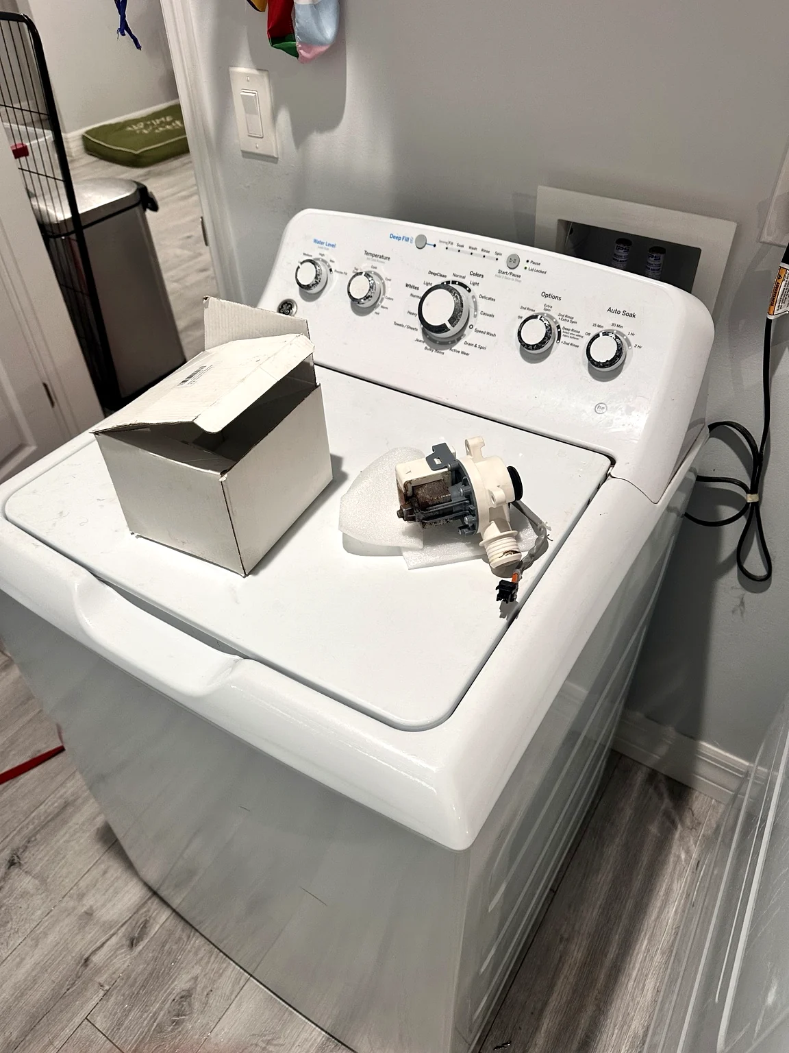 GE GTW465ASN1WW top-load washer with replacement drain pump during repair in Lehigh Acres Florida