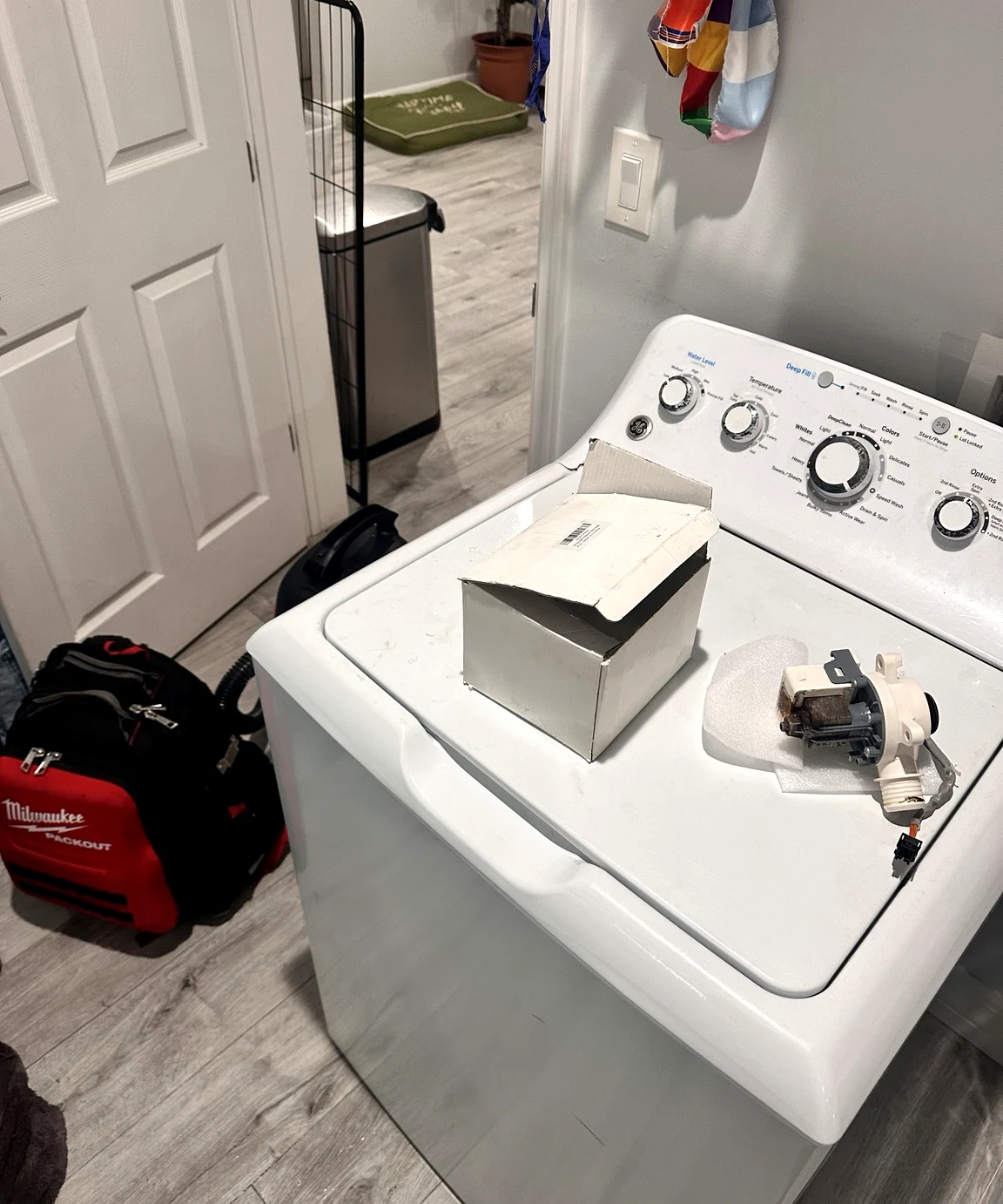 GE GTW465ASN1WW top-load washer and drain pump during repair in Lehigh Acres