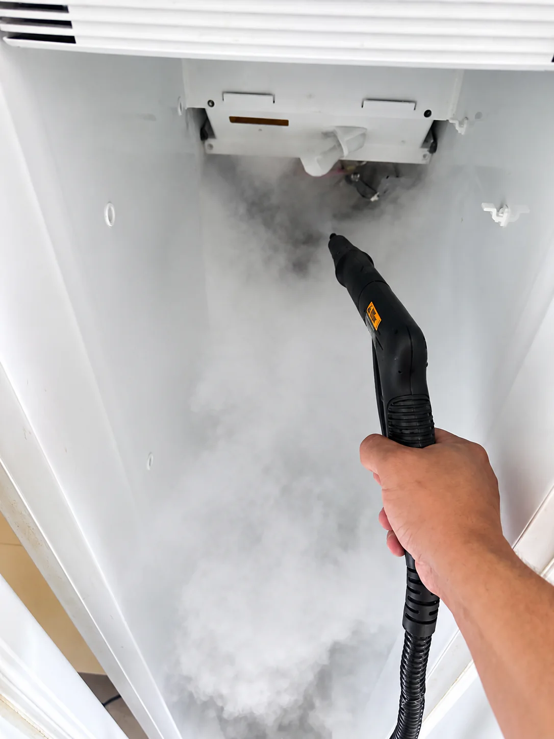 Refrigerator evaporator area being safely defrosted with steam during repair in Lehigh Acres