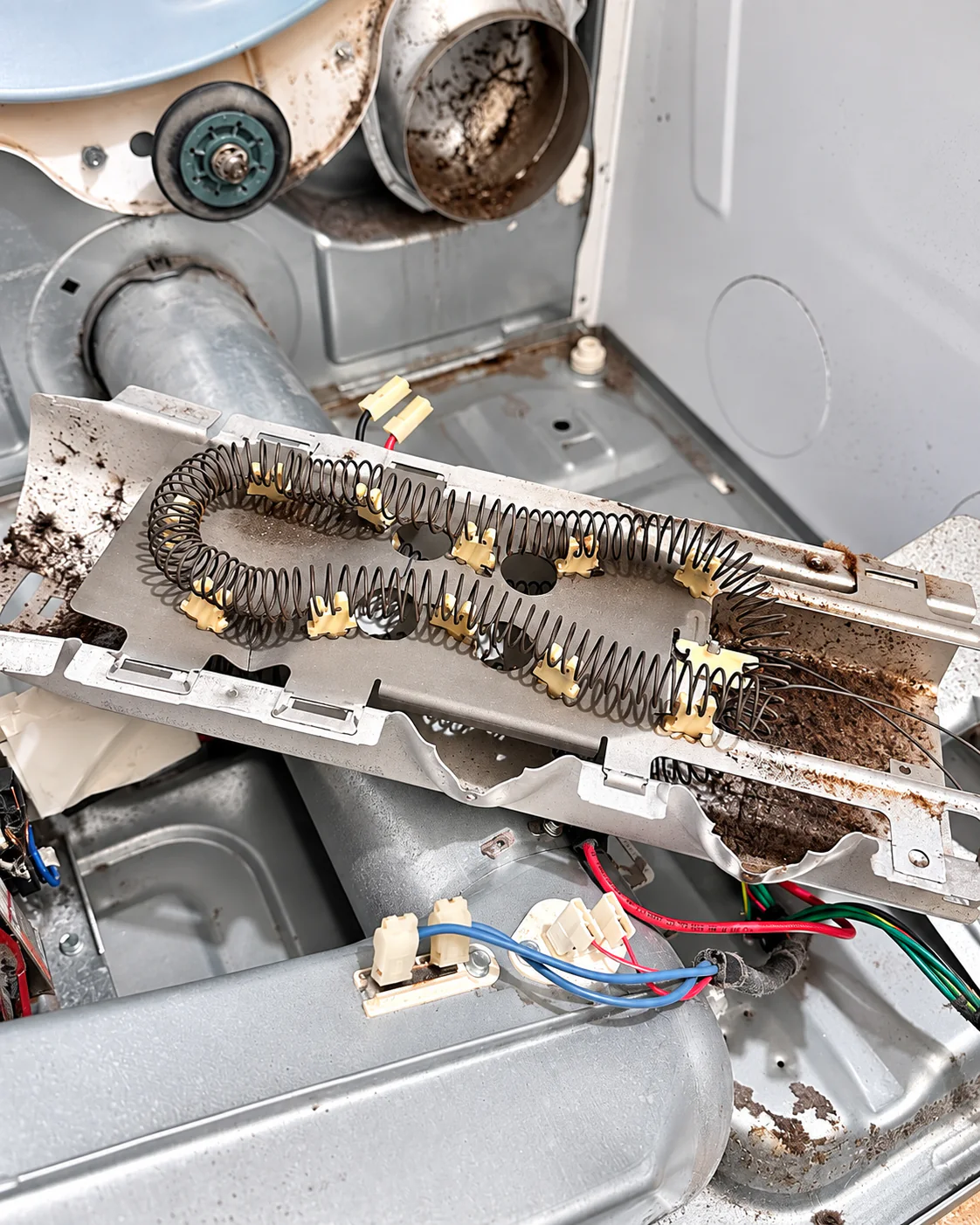 Heating element assembly inside a Whirlpool WED87HEDW1 electric dryer during repair